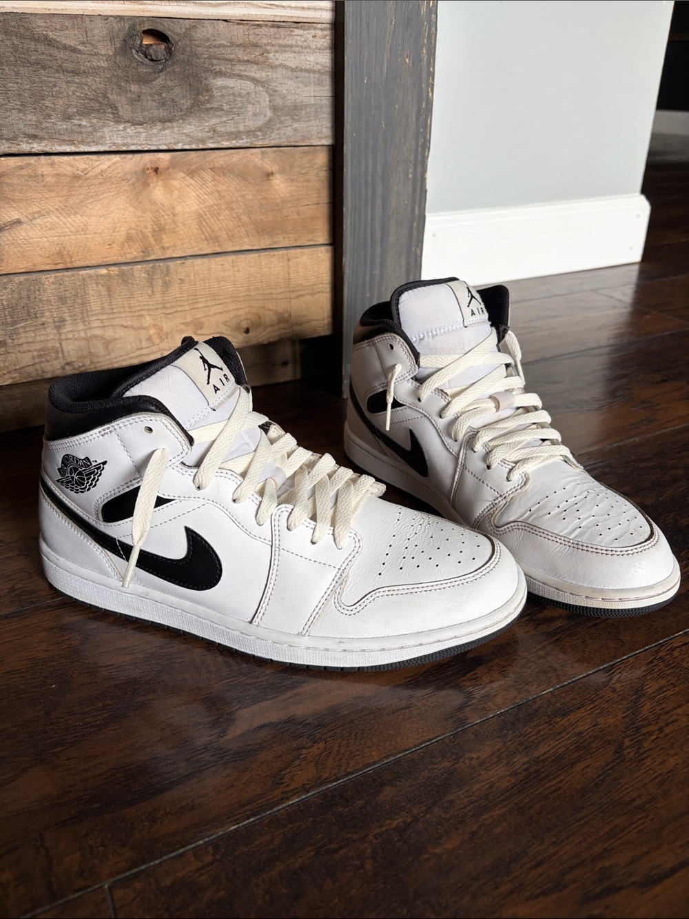 Nike Air Jordan’s White and Black Mid-Top Sneakers with Black Swoosh